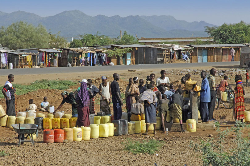 People standing in a queue to collect<p> clean drinking water, Kenya