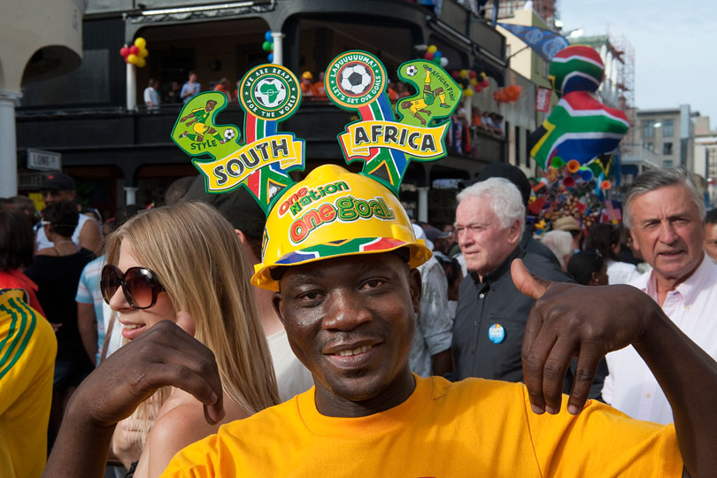 Fan celebrating the draw of the 2010 FIFA <p>World Cup  wearing a Mayoka soccer fan helmet