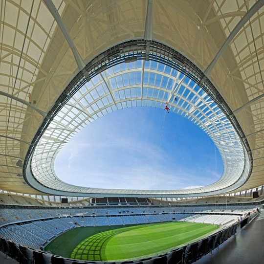 Worker checking the roof structure before<p> opening of the Cape Town Stadium